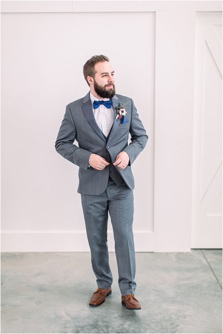 Groom portrait, grey suit, blue bow tie